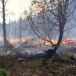 Ben Torkelson (2)/Chelan County Fire District 3 via AP                                In these Tuesday photos provided by Chelan County Fire District 3, logs burn near Leavenworth. The wildfire that started at an old log-storage site has prompted evacuation orders for homes and cabins at a popular Washington state hiking and skiing destination, officials said Wednesday.