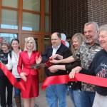 From left, Jessica Hagen, Kelly Grable, Forks Visitor Information Center volunteer Marcia Yanish, Katryna Harris, Port Angeles Deputy Mayor Cherie Kidd, Forks Mayor Bryon Monohon, Forks Chamber of Commerce Executive Director Lissy Andros, Forks Chamber of Commerce President Don Grafstrom and Mike Gurling take part in a ribbon cutting Saturday for the Forever Twilight in Forks Collection at the Rainforest Arts Center. Hagen plays Alice Cullen from the Twilight series during the Forever Twilight in Forks Festival. Grable and Harris are Twilight fans who live out of the area and assisted with getting the collection ready, while Gurling worked with the Visitor Information Center when Twilight started gaining popularity. (Christi Baron/Olympic Peninsula News Group)