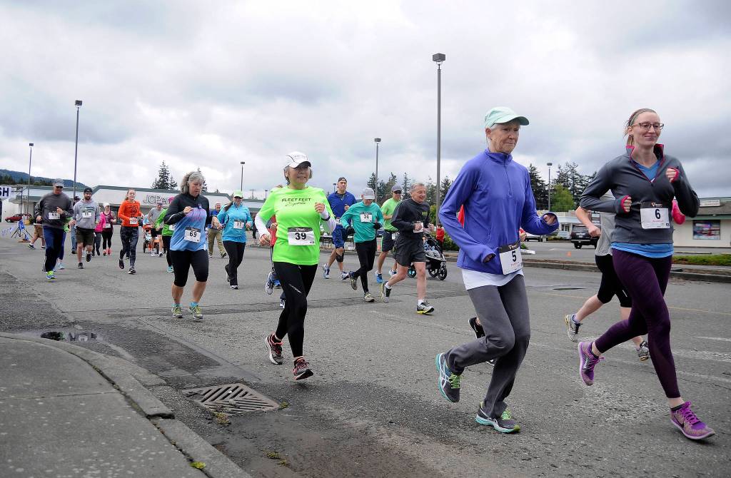 More than 70 participants break from the starting line at Saturday&rsquo;s Sequim Irrigation Festival Fun Run 5K. (Matthew Nash/Olympic Peninsula News Group)