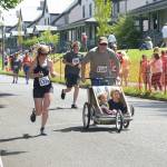 From left, Lea Falkagua, 33, Sean Parsons, 16, Derek Falkenhagen, 36, and Lee Parsons, 53, finish up at the Rhody Run on Sunday, the culmination of almost a week of Rhododendron Festival events in Port Townsend. (Cydney McFarland/Peninsula Daily News)