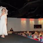 Rebecca Wallace models a lace dress with an umbrella during the Sequim-Dungeness Hospital Guild&rsquo;s annual luncheon and fashion show May 11 at 7 Cedars Casino in Blyn. (Erin Hawkins/Olympic Peninsula News Group)