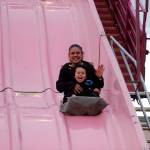 Grandma and grandson Juanita Taylor and Isaiah Loza, 3½, of Sequim, enjoy a quick ride down the Super Slide at the Sequim Irrigation Festival&rsquo;s carnival. Loza said it was their first time down the slide and it was exciting. (Matthew Nash/Olympic Peninsula News Group)