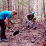 Sequim High School students Sequoia Swindler, left, and Sara Minty clear a trail last Wednesday on the Miller Peninsula as part of a project led by Powell Jones, executive director of the Dungeness River Audubon Center, to bring local youths into the wilderness. The trail was funded by a grant through the U.S. Forest Service. (Matthew Nash/Olympic Peninsula News Group)