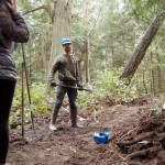 Powell Jones, executive director of the Dungeness River Audubon Center, shows students how to use tools like a McLeod for clearing trails. Each student got to try different tools as they worked to clear a trail over a few hours last week. (Matthew Nash/Olympic Peninsula News Group)