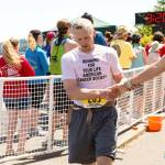 North Olympic Discovery Marathon                                Port Angeles&rsquo; Tom Wahl, left, shakes the hand of a fellow runner after crossing the finish line of the North Olympic Discovery Marathon in 2016. Wahl has finished all 14 marathons and will run in the 15th annual event Sunday.