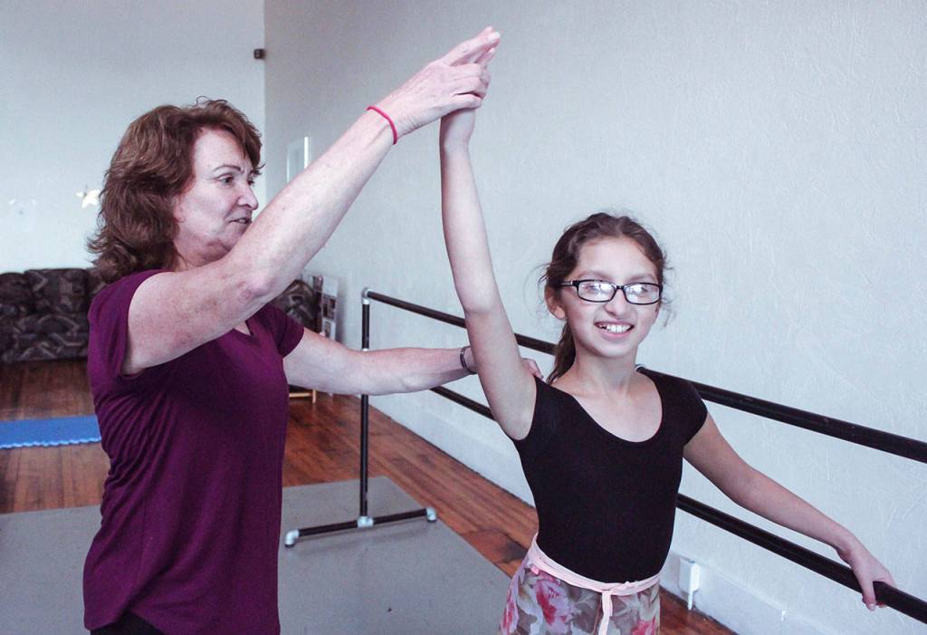 Mary Marcial helps out her granddaughter, Amara Gonzalez. (Jessie Young)