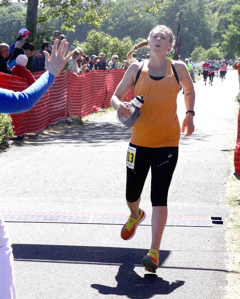 Women&rsquo;s marathon winner Jenine Adam of Bainbridge Island nears the finish line in Port Angeles. (Dave Logan/for Peninsula Daily News)