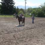 Under mom Tanya Hull&rsquo;s guidance, 4-year-old Levi Hull directs the horse&rsquo;s hooves inside the white lines for a clean run during the keyhole event at last Sunday&rsquo;s Patterned Speed Horse Association show at Quarter Moon Race in Carlsborg. (Karen Griffiths/for Peninsula Daily News)