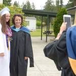Quilcene senior Bailey Kieffer gets a photo taken with teacher Katie Allen before the Quilcene graduation ceremony Saturday. (Cydney McFarland/Peninsula Daily News)