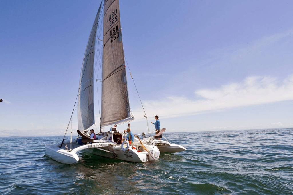 Team Big Broderna sails through calm seas and sunny skies on Day 3 of the Race to Alaska. Team Big Broderna was one of the three trimarans battling for the lead on Day 4. (Katrina Zoe Norbom/R2AK)