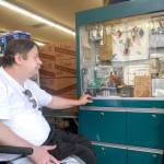Douglas Schwab, owner of Port Crescent Trading Co. in Joyce, looks over a display of regional memorabilia left behind after his store was burglarized between last Tuesday evening and Wednesday morning. (Keith Thorpe/Peninsula Daily News)