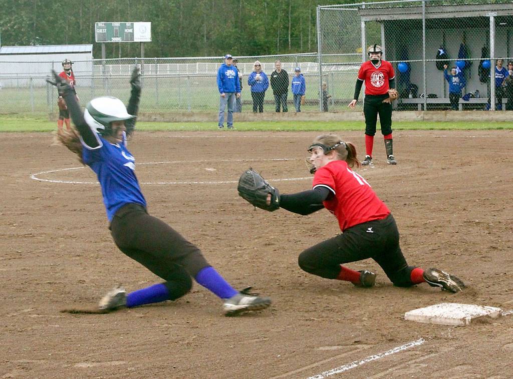 Dave Logan/for Peninsula Daily News Olympic Labor Council&rsquo;s Peyton Rudd slides into third base as Jim Pharmacy&rsquo;s Saylah Commerton prepares to deliver the tag. Rudd was out but OLC won the City Championship 3-0.