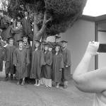 Crescent School secretary Linda Sage, right, takes a group photo of members of the school&rsquo;s class of 2017 before the seniors prepared to march to commencement in the gym Saturday in Joyce. Fifteen seniors were eligible for graduation for the 2016-17 academic year.
