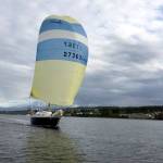 Team West Coast Wild Ones, currently the fastest monohull craft in this year&rsquo;s Race to Alaska, sail with one of their many spinnakers up during low winds Tuesday. This particular sail&rsquo;s name is Helga. (R2AK)
