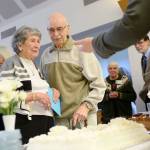 Elaine and Ed Berrington look over cakes during a reception at St. Andrews Episcopal Church on Sunday, honoring them for their 75th wedding anniversary. (Jesse Major/Peninsula Daily News)