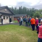 Rod Barrow, left, project manager for G. Little Construction, and Claudia Edmondson, executive director, welcome supporters to new housing at Camp Beausite on Saturday. (Cheryl Smith/Camp Beausite NW)