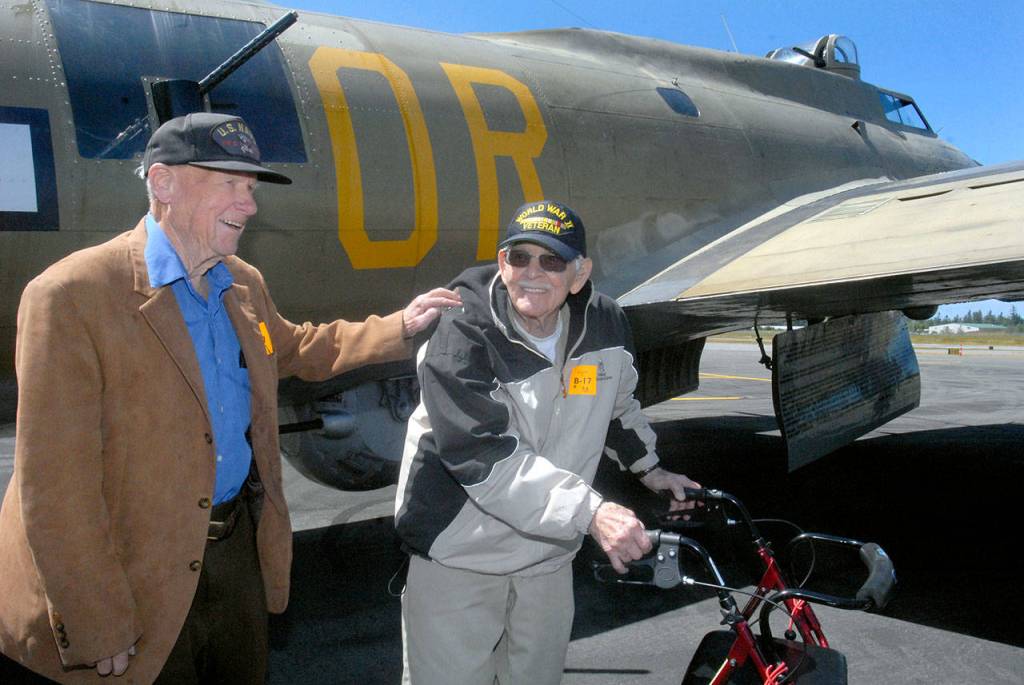Veterans Frank Meek of the U.S. Navy and Don Alward of the U.S. Marine Corps show delight at the end of their flight aboard a restored B-17 bomber on Wednesday at William R. Fairchild International Airport in Port Angeles. (Keith Thorpe/Peninsula Daily News)