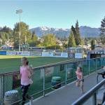 The Olympics tower over Civic Field as kids enjoy a Lefties home game last week. (Pierre LaBossiere/Peninsula Daily News)