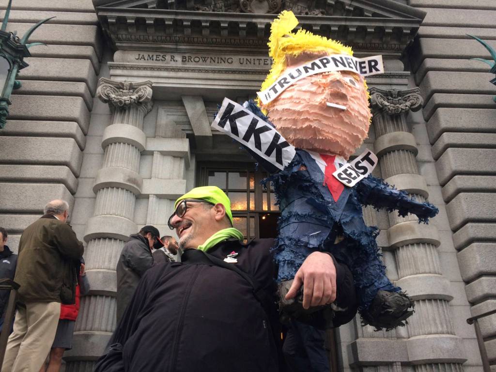 In this Feb. 9 photo, a protester is seen outside the 9th U.S. Circuit Court of Appeals building in San Francisco. (Haven Daley/The Associated Press)