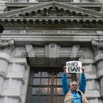 In this Feb. 7 photo, Karen Shore holds up a sign outside of the 9th U.S. Circuit Court of Appeals in San Francisco. (Jeff Chiu/The Associated Press)