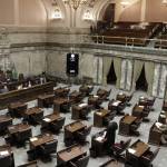 Republican Sen. Joe Fain, standing bottom center, speaks on the Senate floor during adjournment of a second special session Wednesday in Olympia. Lawmakers will need a third special session to complete their work on a new two-year state budget. (Rachel La Corte/The Associated Press)