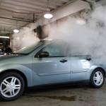 In this April 16, 2015, photo, smoke created by water vapor billows out of the windows of a car during a demonstration by the Colorado Department of Transportation in southeast Denver. (David Zalubowski/The Associated Press)
