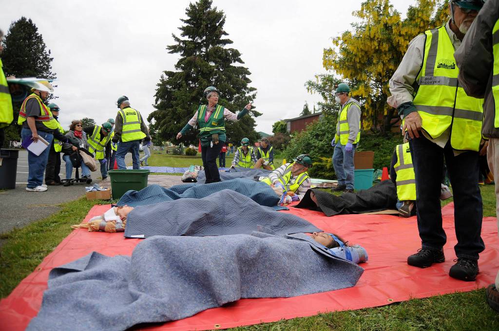 Community Emergency Response Team members treat &ldquo;victims&rdquo; of an earthquake during Saturday&rsquo;s drill. (Michael Dashiell/Olympic Peninsula News Group)