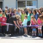Greywolf Elementary School Principal Donna Hudson helps Bianca Lopez and Benjamin Smith with the ribbon-cutting at Greywolf Elementary School&rsquo;s new kindergarten classroom building, constructed using cross-laminated timber, on Wednesday. (Michael Dashiell/Olympic Peninsula News Group)