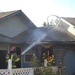 Matthew Nash (2)/Olympic Peninsula News Group                                A fire spread through the attic of a home on the 200 block of Griffith Farm Road on Sunday. Clallam County Fire District No. 3, with support from Clallam County Fire District No. 2 extinguished the fire in about two hours.