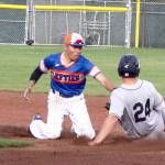 Port Angeles&rsquo; Austyn Tengan, left, tags out Walla Walla&rsquo;s Nick Nyquist on a steal attempt at second base during a game earlier this month. (Dave Logan/for Peninsula Daily News)