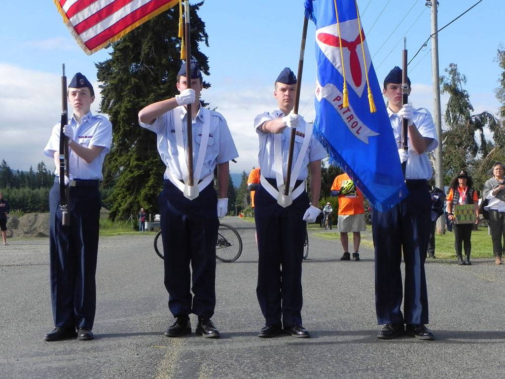 Civil Air Patrol cadets from the Dungeness Composite Squadron in Sequim present the nation&rsquo;s colors at the start of the North Olympic Discovery Marathon and half-marathon in Blyn and Agnew on Saturday morning. In the color guard are cadets Mikhail Ostrovsky, Malachi Delano, Jordan Hurdlow and Dylan Perreira. (Mark Swanson/Peninsula Daily News)
