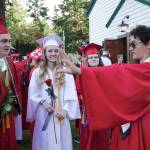 Henry Veitenhans, right, regales fellow graduating seniors Gannon Short, Rosemary D&rsquo;Andrea and Helena Stafford, from left, with tales of his harrowing adventure while crossing the Strait of Juan de Fuca in gale-force winds during Thursday&rsquo;s Race to Alaska. The 17-year-old senior entered the race as his senior project. He arrived in Victoria on Friday morning, after having put in for shelter about a mile from Victoria Harbor, then made his way back to Port Townsend to attend Friday&rsquo;s graduation. (Steve Mullensky/for Peninsula Daily News)