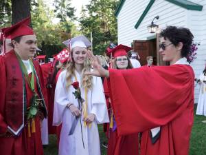 Henry Veitenhans, right, regales fellow graduating seniors Gannon Short, Rosemary D&rsquo;Andrea and Helena Stafford, from left, with tales of his harrowing adventure while crossing the Strait of Juan de Fuca in gale-force winds during Thursday&rsquo;s Race to Alaska. The 17-year-old senior entered the race as his senior project. He arrived in Victoria on Friday morning, after having put in for shelter about a mile from Victoria Harbor, then made his way back to Port Townsend to attend Friday&rsquo;s graduation. (Steve Mullensky/for Peninsula Daily News)