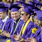 Shawn Jones, left, and fellow Sequim High School graduates give a hand to Grant Pierson, center, who gave two speeches at the commencement ceremony Friday night: one as the faculty-selected speaker and a second as one of four Sequim High co-valedictorians. (Michael Dashiell/Olympic Peninsula News Group)