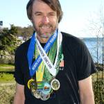 North Olympic Discovery Marathon                                Port Angeles&rsquo; Tom St. Amand wears his North Olympic Discovery Marathon medals. St. Amand has completed all 14 marathons to date, and will run in Sunday&rsquo;s 15th annual race.