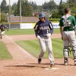 Dave Logan/for Peninsula Daily News Wilder Senior&rsquo;s Gavin Guerrero scores while teammate Matt Hendry rounds third base during a game against Lakeside Recovery earlier this summer.