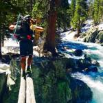 In this June 16 photo, Jake Gustafson crosses Bear Creek along the Pacific Crest Trail near Kings Canyon National Park, Calif. (Wesley Tils via AP)