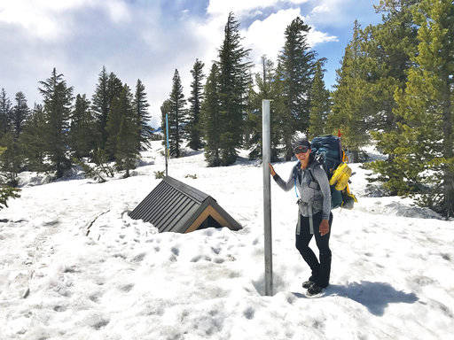 In this May 29 self-portrait photo taken with the help of a timer, Anya Sellsted stands in Mammoth Lakes, Calif. Sellsted had traversed the highest snow-covered passes and forded raging rivers during her hike from Mexico to Canada when she ran into trouble in the high Sierra Nevada mountains. (Anya Sellsted via AP)