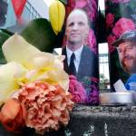 Candles with photos of Taliesin Namkai-Meche, right, and Ricky Best on them sit at a memorial for the two men in Portland, Ore., on May 31. (Don Ryan/The Associated Press)