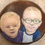 Pam Fries painted this memorial rock of 18-month-old Krystal Wiggins and 4-year-old Damien Wiggins after the two were killed in a flash flood in northeastern Arkansas on April 29.