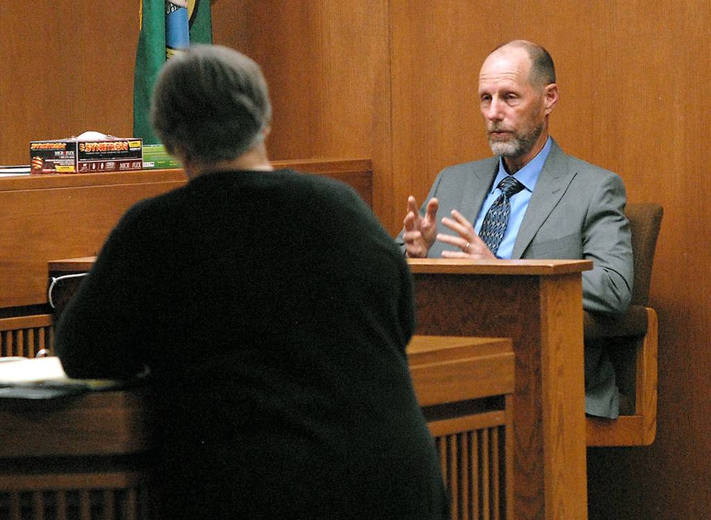 Former Port Angeles Police Chief Tom Riepe, right, answers questions from former county Prosecuting Attorney Deborah Kelly during testimony in a hearing for Tommy L. Ross Jr. on Tuesday in Clallam County Superior Court. (Keith Thorpe/Peninsula Daily News)