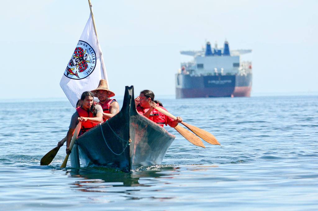 The Lower Elwha Tribe&rsquo;s canoe family arrives at Hollywood Beach on Monday. (Jesse Major/Peninsula Daily News)