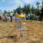 Guests and dignitaries take a ceremonial first disc toss to officially open Clallam County&rsquo;s Rainshadow Disc Golf Park on the Miller Peninsula near Blyn on Wednesday. (Keith Thorpe/Peninsula Daily News)