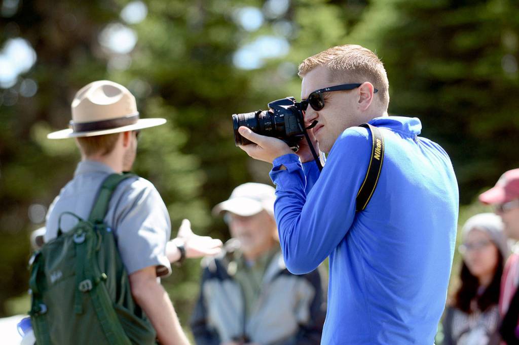Mikah Meyer takes a picture during a short ranger-led hike at Hurricane Ridge on Wednesday. (Jesse Major/Peninsula Daily News)