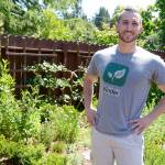 Sam Lillie, founder and CEO of Vinder, stands in his backyard herb garden in Port Townsend. (Cydney McFarland/Peninsula Daily News)