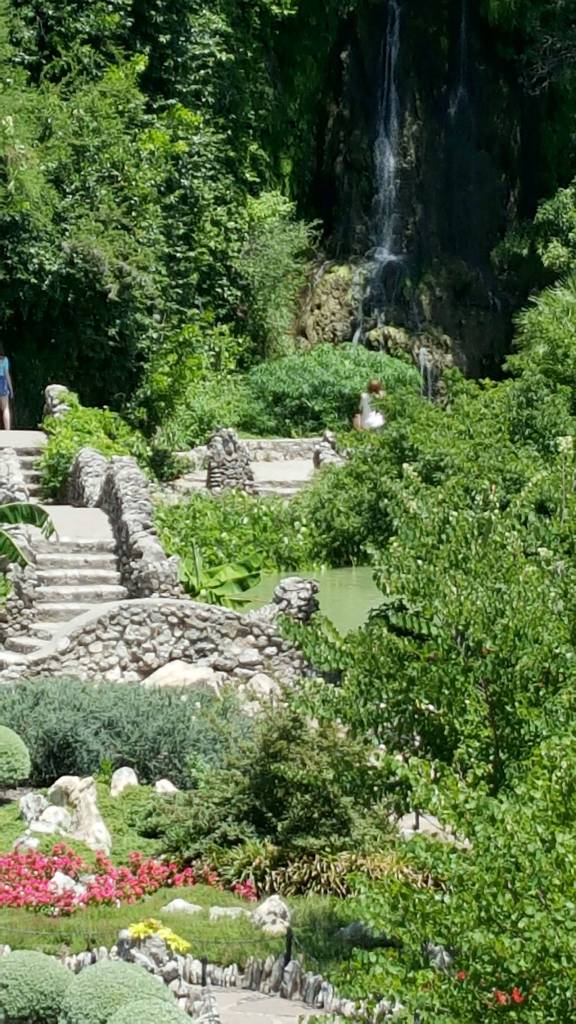 Looking up the stone pathway to the waterfalls cascading over the old quarry edge. (Andrew May/for Peninsula Daily News)