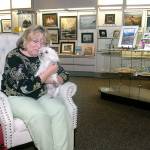Sky Heatherton, along with her dog, Sasha, sits in her Heatherton Gallery at The Landing mall Friday on the Port Angeles waterfront. (Keith Thorpe/Peninsula Daily News)