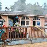 A mobile home at 206 N. Carne St. incurred extensive damage in a fire Wednesday evening. Two dogs perished but a third was saved by firefighters. (Jay Cline/Clallam Fire District No. 2)