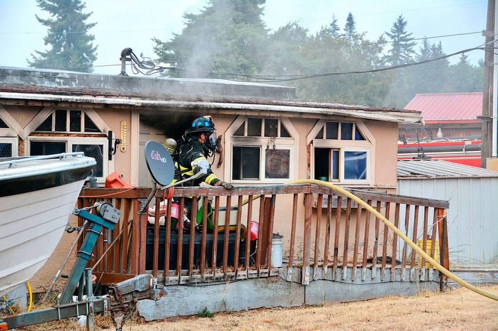 A mobile home at 206 N. Carne St. incurred extensive damage in a fire Wednesday evening. Two dogs perished but a third was saved by firefighters. (Jay Cline/Clallam Fire District No. 2)