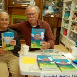 Tim Wheeler, pictured with his wife, Joyce, signs copies of &ldquo;News from Rain Shadow Country&rdquo; at Sequim Museum & Arts in early July. (Erin Hawkins/Olympic Peninsula News Group)